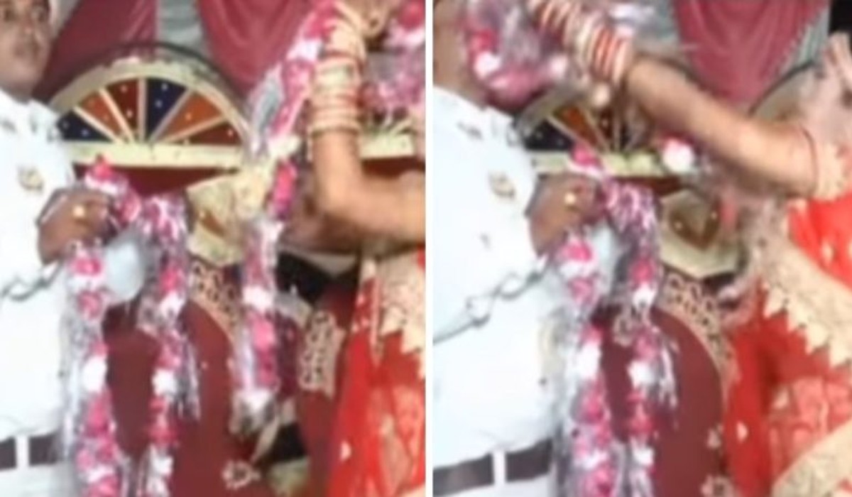 Angry bride and groom throw garland at each other